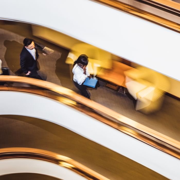 Business People Walking Down The Hallway